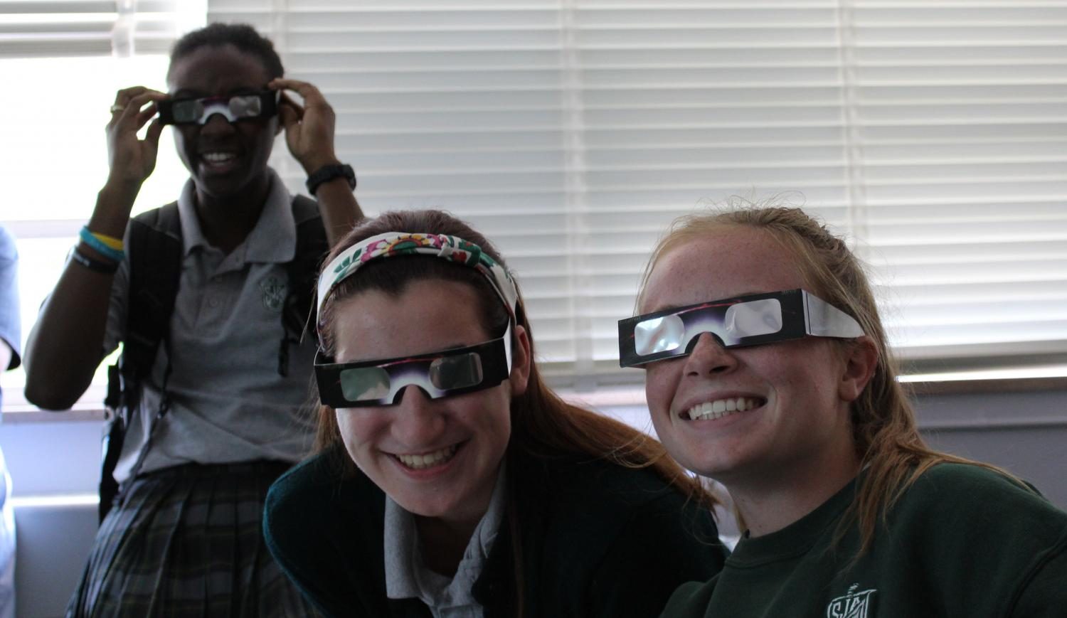 Seniors Annmarie Tyson, Ava Frigo, and Tara Lottes show off their eclipse glasses. 