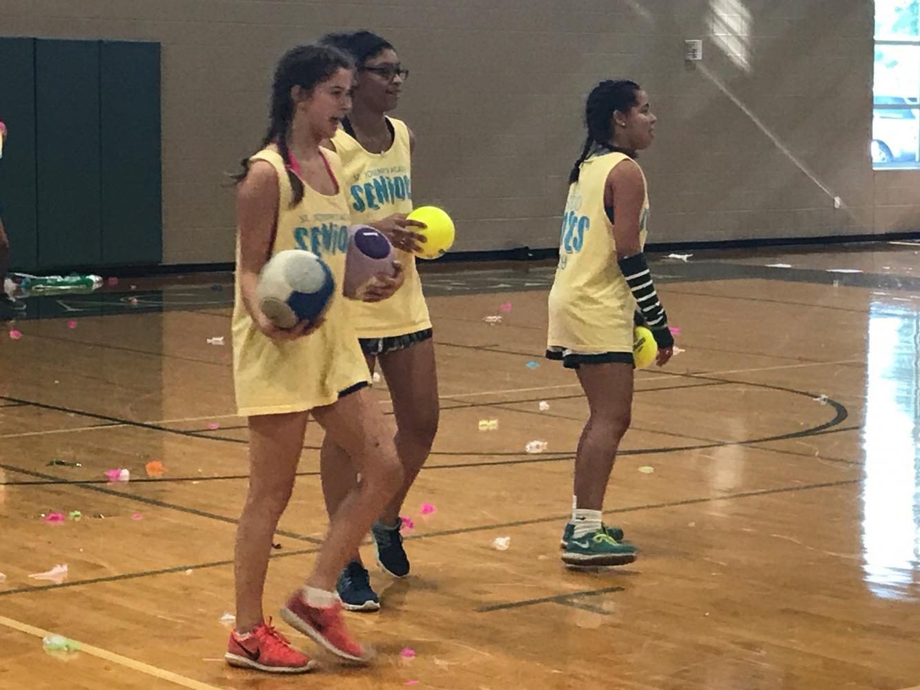 Seniors Annie Weiss, Jamie Connors and Claire Shackleford taunt the faculty during dodge ball game on Aug. 25.