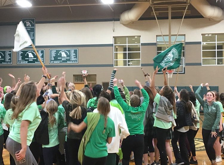 At+the+end+of+the+game%2C+St.+Joe+students+storm+the+court+and+celebrate+their+victory+in+basketball.