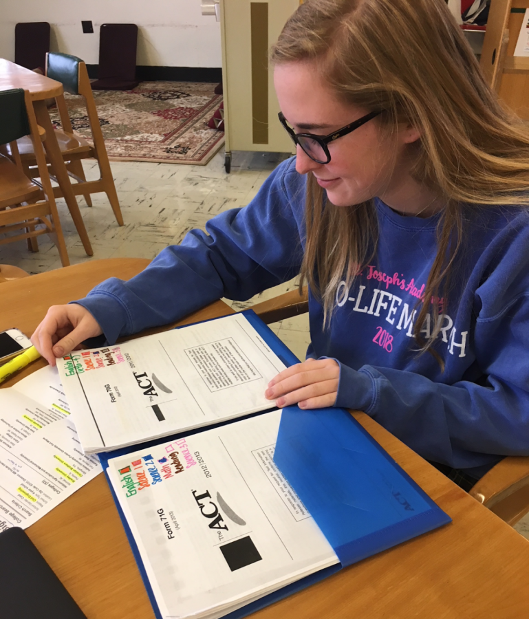 Junior Gracie Fiala studies for the ACT with an ACT packet.