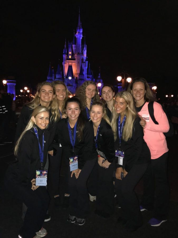 The team poses in front of Cinderella’s Castle.