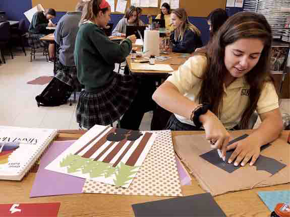 Senior Kenzie Burke creates Little Women poster for design class. Photo taken by: Alyssa Brinegar