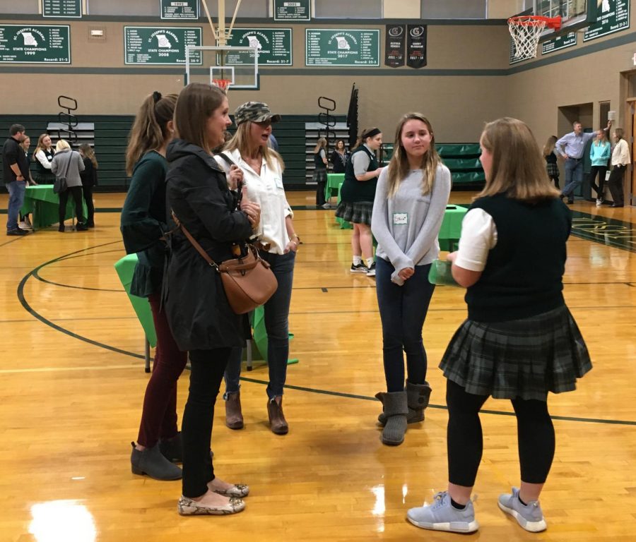 Student ambassadors greet families in the gym before taking them on a tour of St. Joseph. Photo: Claire Price 