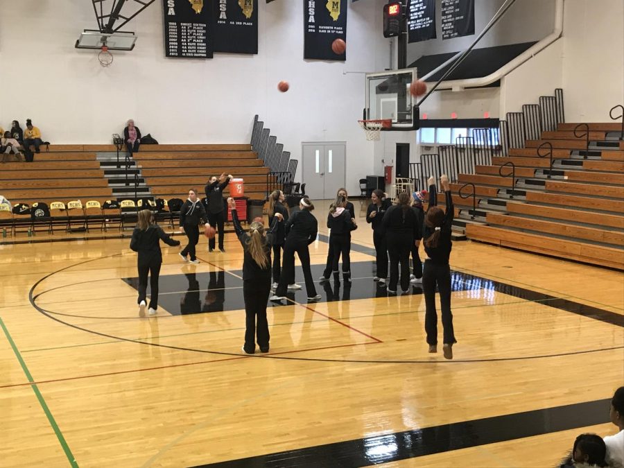 The Varsity team warming up before one of their games. Picture taken by Ella Kertz.
