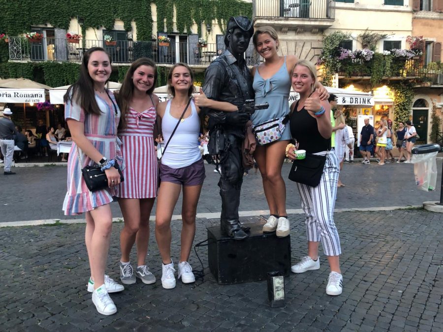 Seniors Allison Leahy, Kathryn Sands, Taryn OHearne, Ainsley Hurford, and Kate Diedrich pose with a statue in Italy.