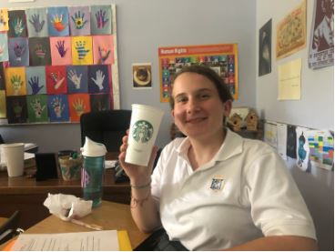 Sophomore Cate Van Luven shows off both her reusable water bottle and reusable Starbucks cup.