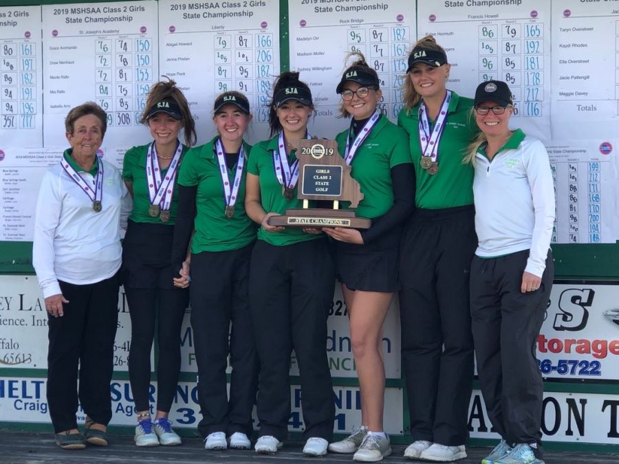 The+golf+team+poses+with+their+fourth+consecutive+state+trophy.