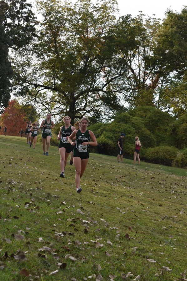 Senior Kathryn James striving for victory during a cross country meet.