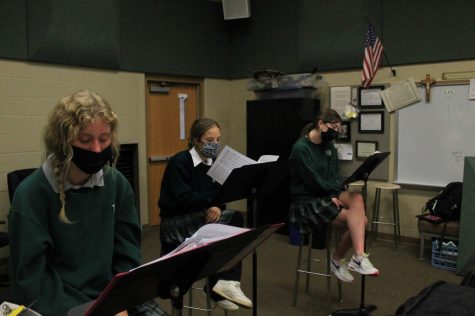 Sophomore Meredith Dunn, junior Kate Theerman-Rodriguez, and senior Kathleen Dolan practice for the upcoming Winter Concert.