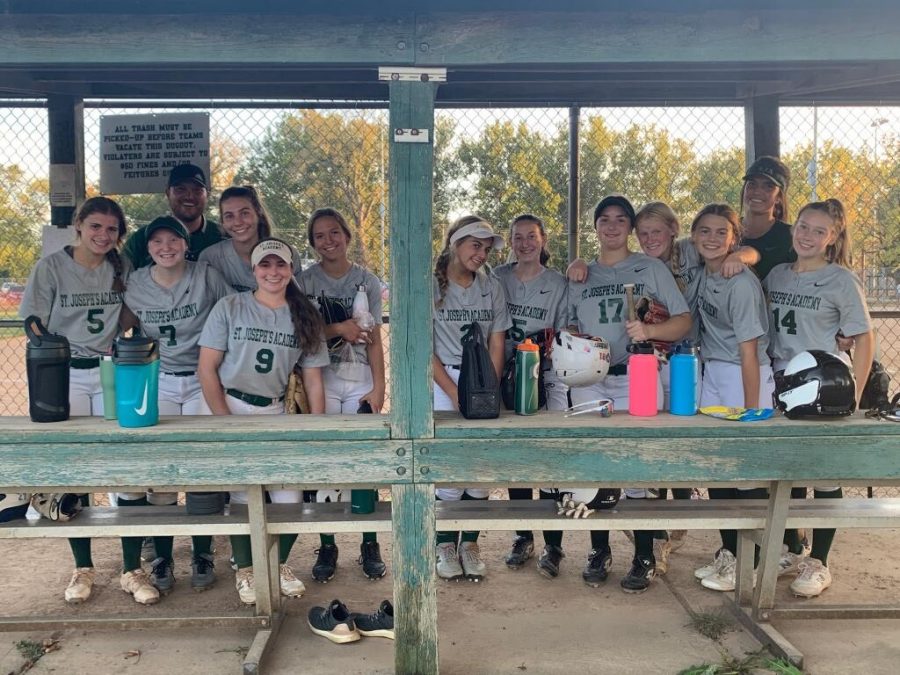 St. Joe Varsity Softball team in the dugout after their big win against Nerinx Hall.
