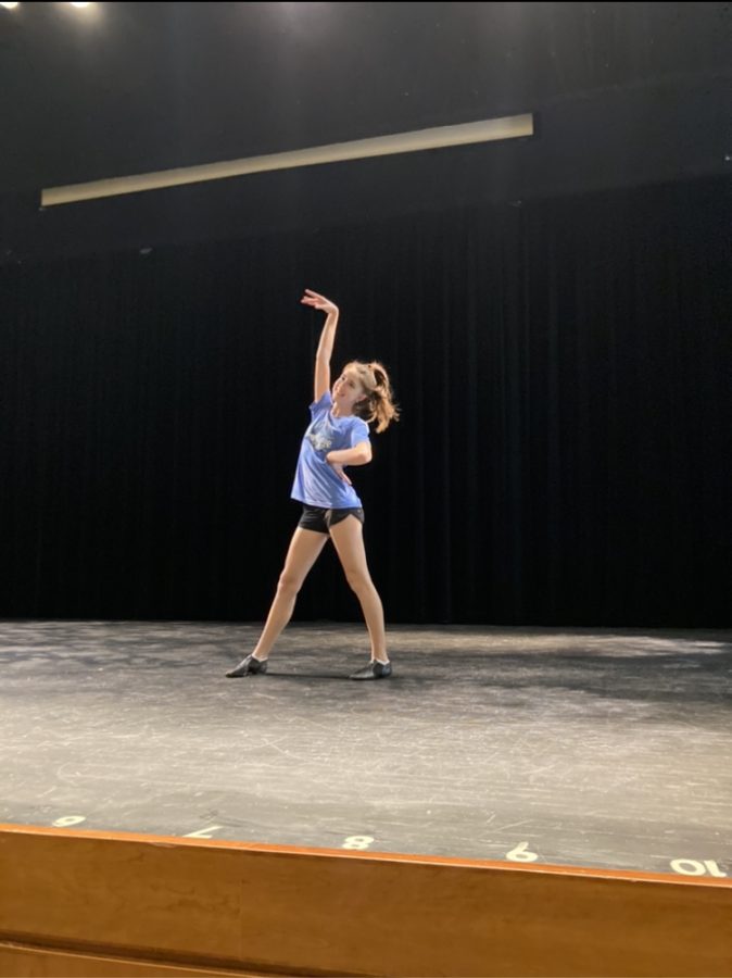 Sophomore Kathryn Portman practices her choreography on stage. 