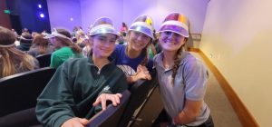 Freshmen Avery LeClair, Savannah Stumpf, and senior STUCO representative Lucie McMillen display their freshmen hats during Community Time.