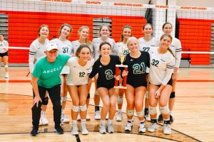 The St. Joe JV volleyball team (Quinlan Ertl 26, Ashley Eveler 26, Maddy Sands 25, Kathryn Teepe 26, Megan Welker 26, Ella Jackson 26, Emily Rines 25, Chelsea Plunkett 26, Emma Kelly 25, Ayva DeGreeff 25, and Maddie Hannis 25) and substitute coach Ms. Beekman huddle together for a team photo after winning the JV Incarnate Word volleyball tournament.