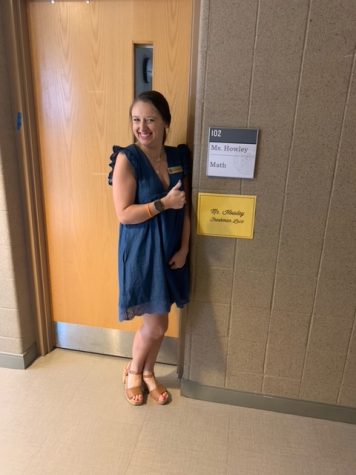 Ms. Howley poses at her classroom door. 