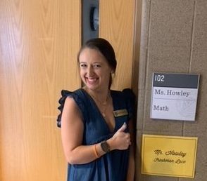 Ms. Howley poses at her classroom door. 