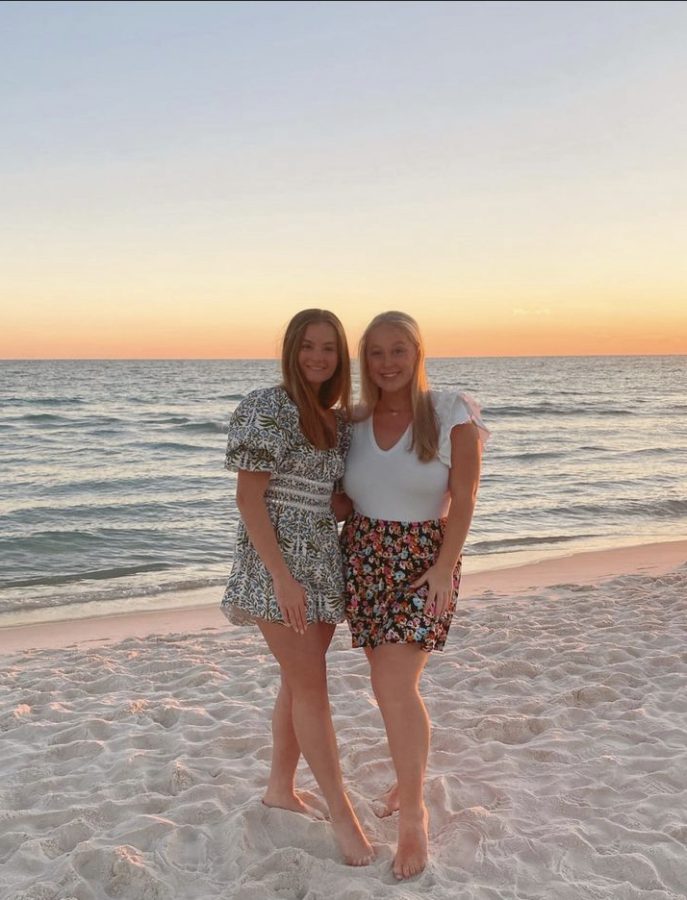 (From left to right) Juniors Annie Malloy and Karina Weiss smile during sunset on Rosemary Beach, Florida. 