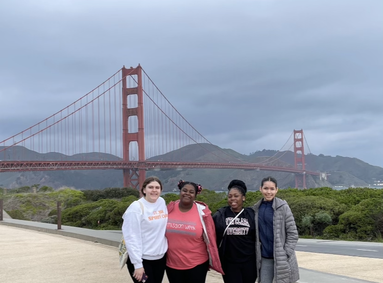 Lauren S. 24, Malae H. 24, Renee O. 24, and Yareli M. 25 pose in front of the Golden Gate Bridge. 