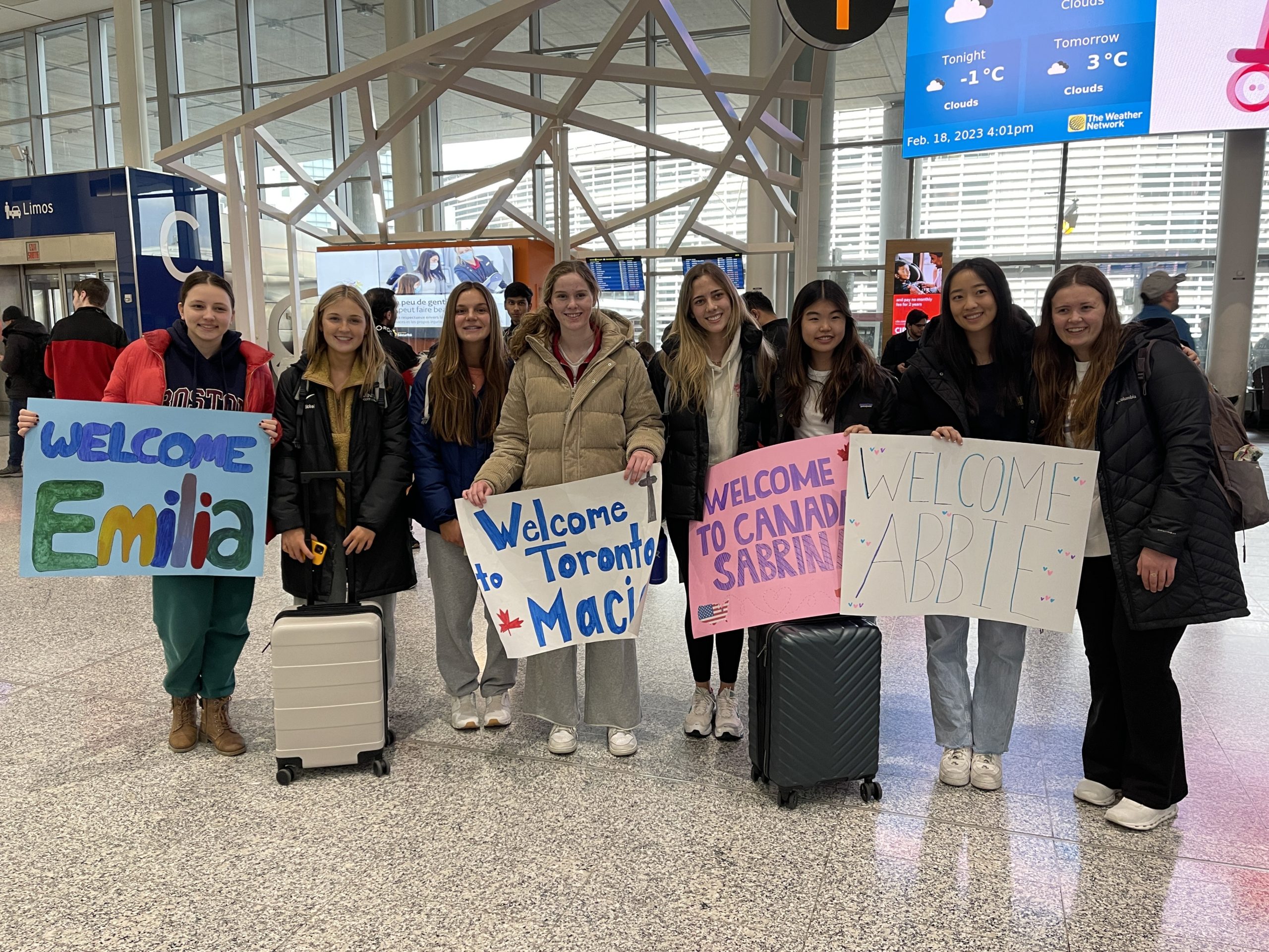 Abbie, Emilia, Sabrina, and Macie being greeted at the airport by their hosts, Nicole, Emily, Sophia, and Charlotte.