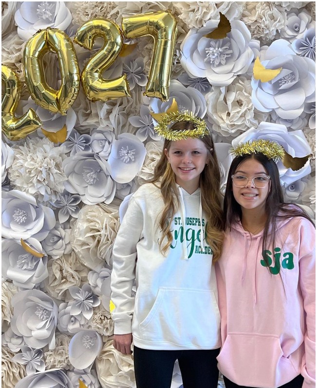 Two members of the SJA Class of 2027 smile at their Welcome Day celebration.