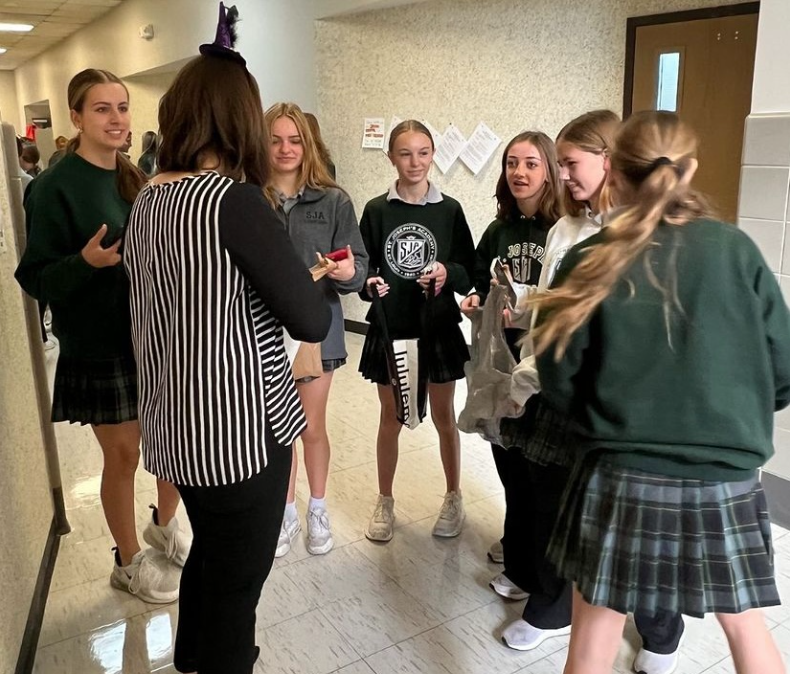 Ms. Boul from the Theology Department hands out candy to eager SJA students.
