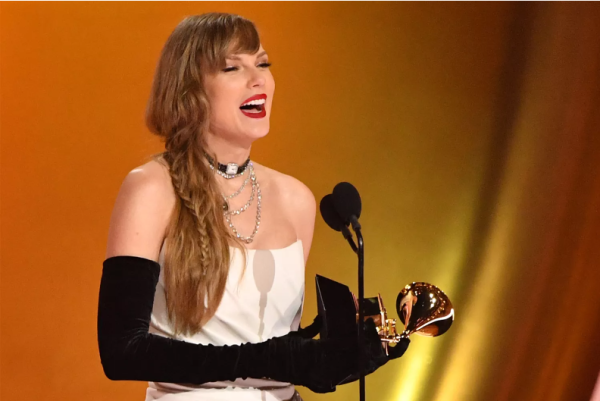 Taylor Swift accepting her Grammy for Album of the Year. 