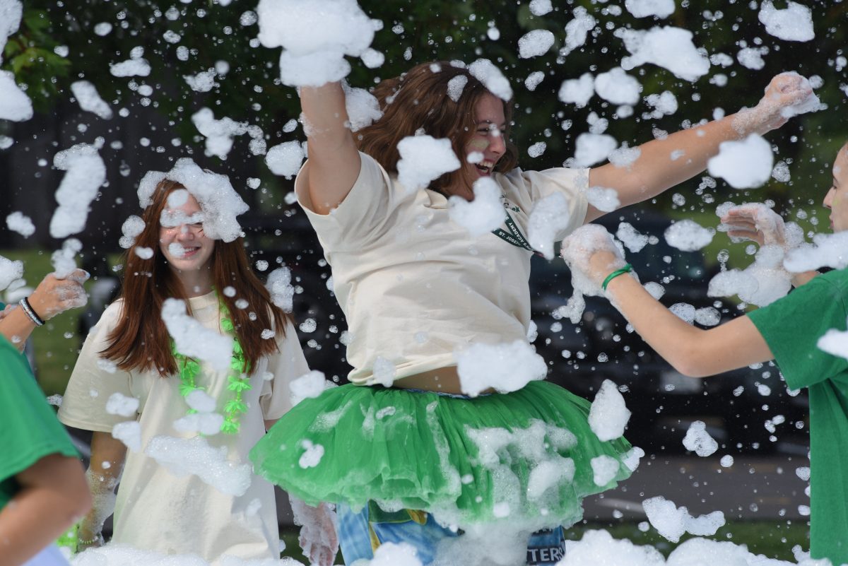 Leila Pheonix '27 and Izzy Stadnyk '26  play in the bubble machine with their friends during St. Joe Day.