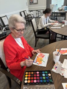 A Nazareth resident paints an autumn scene at a "Watercolor With the Sisters" session.