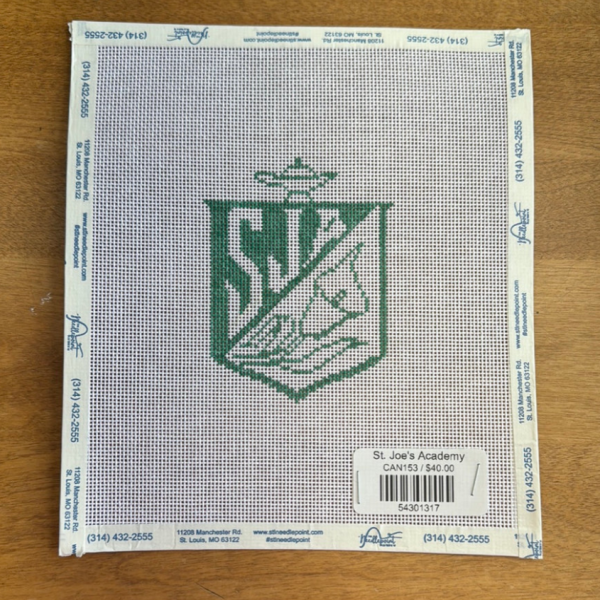 A canvas with a St. Joseph Academy crest that a local needlepoint store sells.
